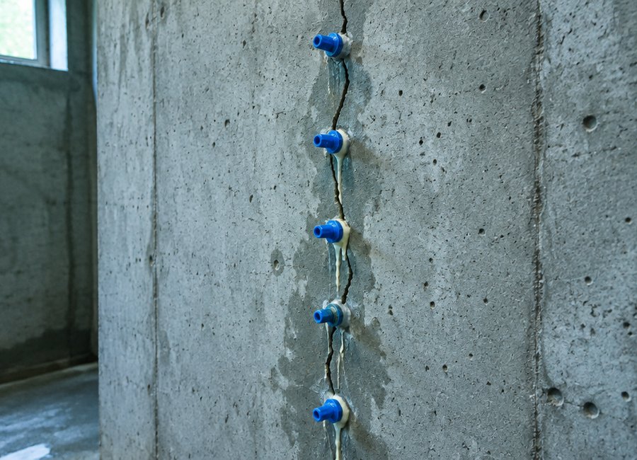 Foundation crack sealed with injection along a poured concrete wall